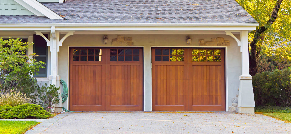 two car garage with wooden doors and small windows at top