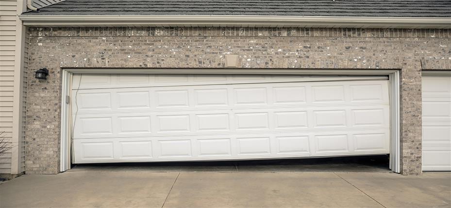 Broken garage door. Misaligned.