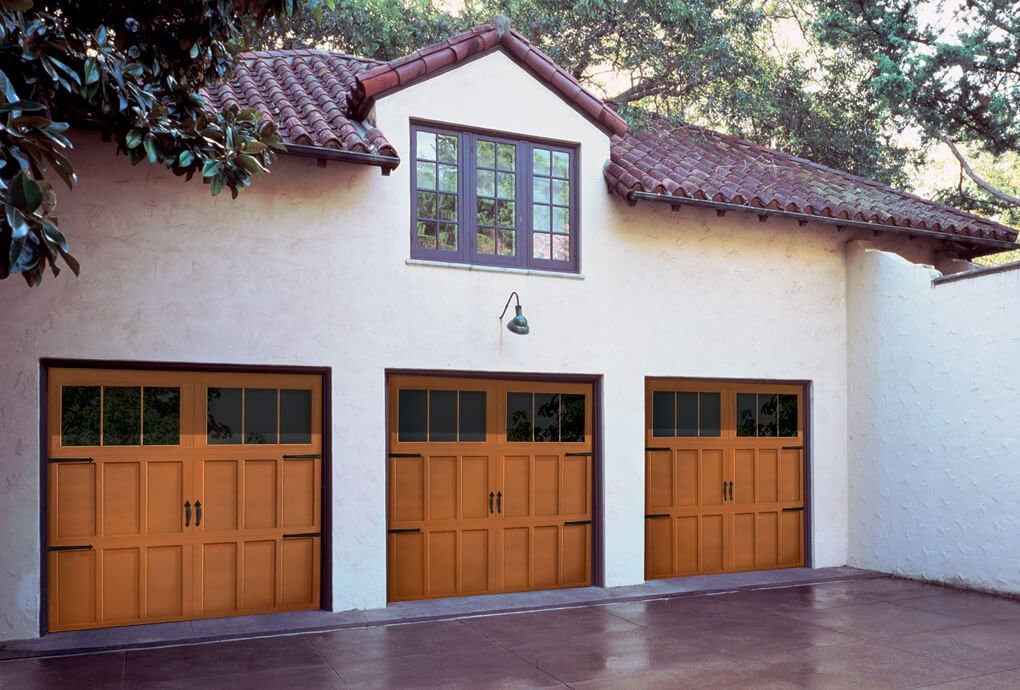 Garage door style of windows across the top, in lights brown color with black metal fixtures on the outside.